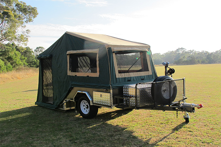 A setup camper trailer on open grassland