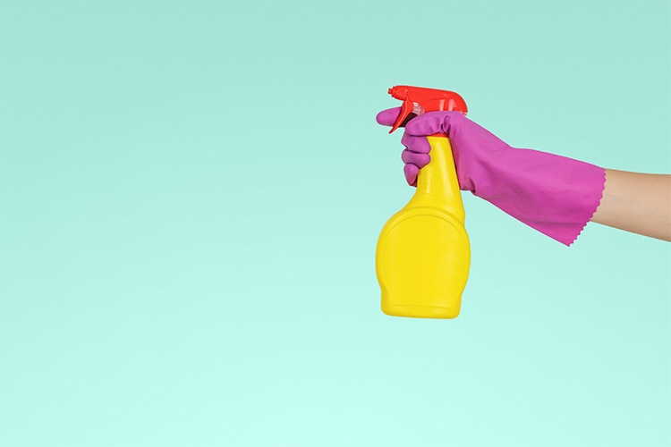 Yellow and red spray bottle on a aqua background