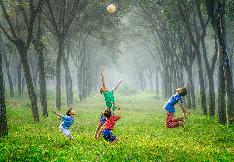 Kids playing in a green field
