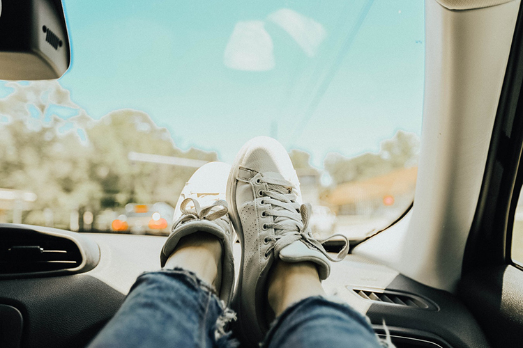 Feet on car dashboard
