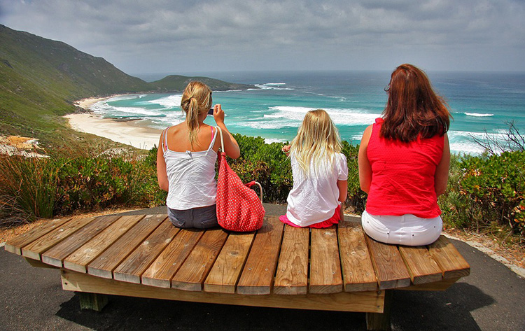three girls looking at sea