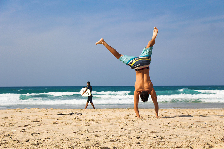 man jumping near the beach