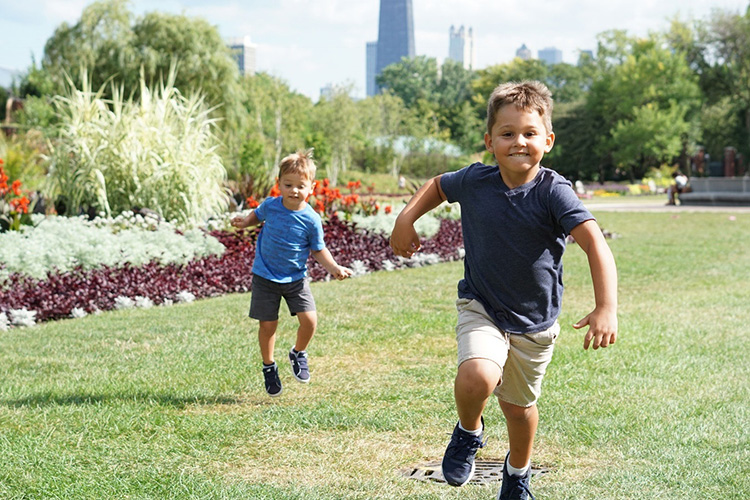 Brothers running in a park