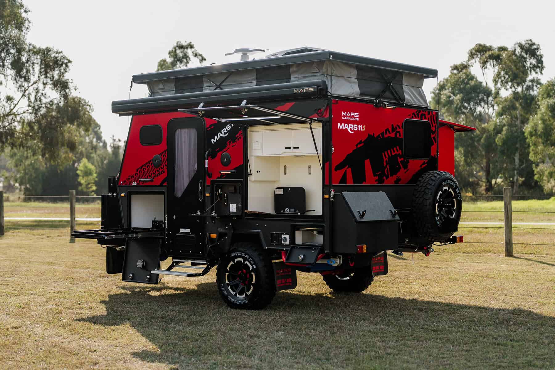 Mars 11S offroad hybrid caravan exterior rear angled view of fully set up van