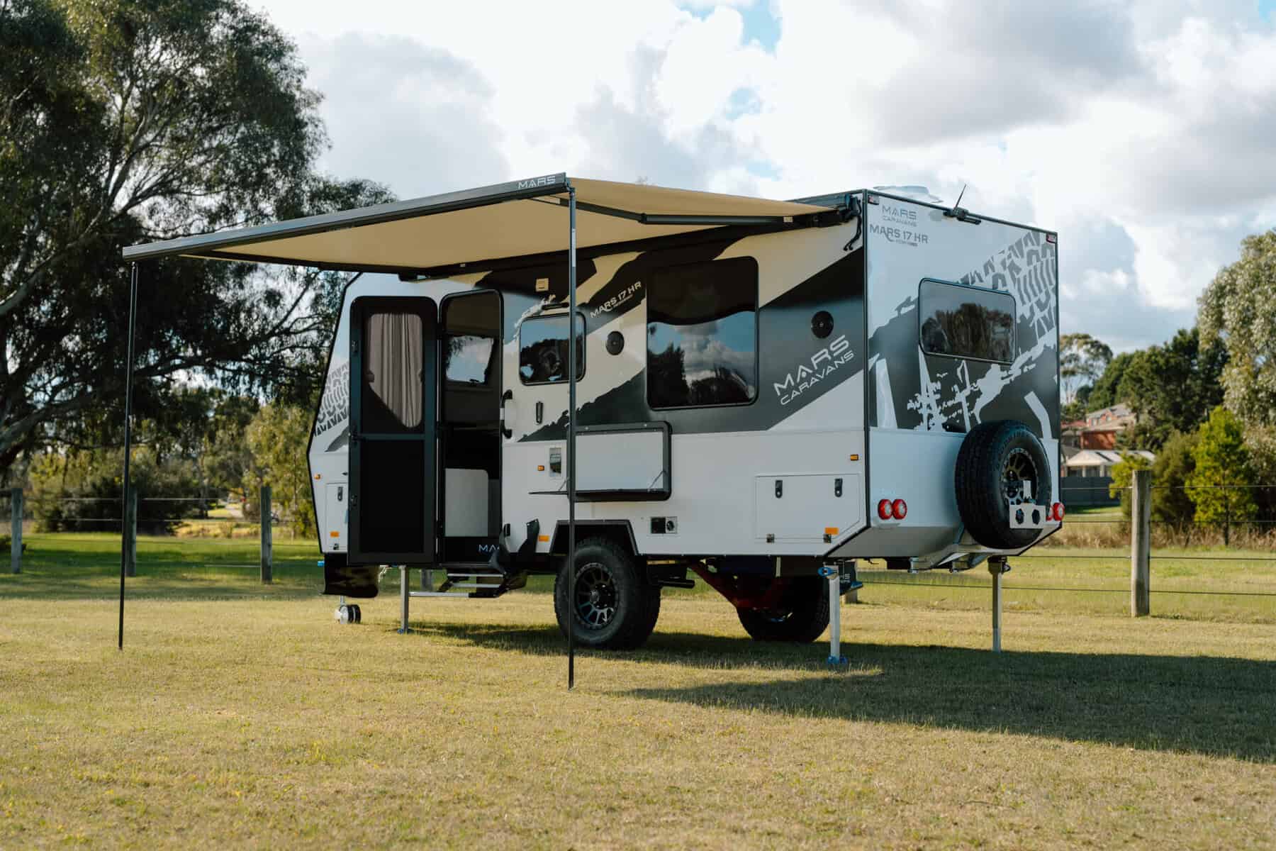 Mars 17HR lightweight on road couples caravan exterior rear angled view with extended waterproof awning