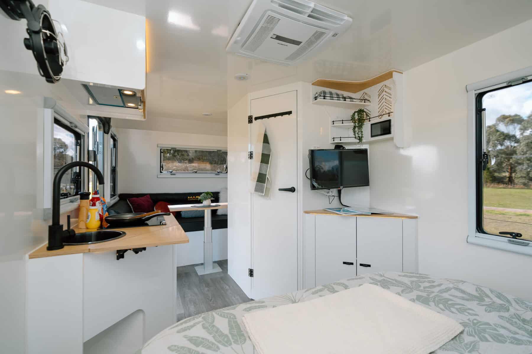 Mars 17HR lightweight on road couples caravan interior bed view of club lounge and cooking area