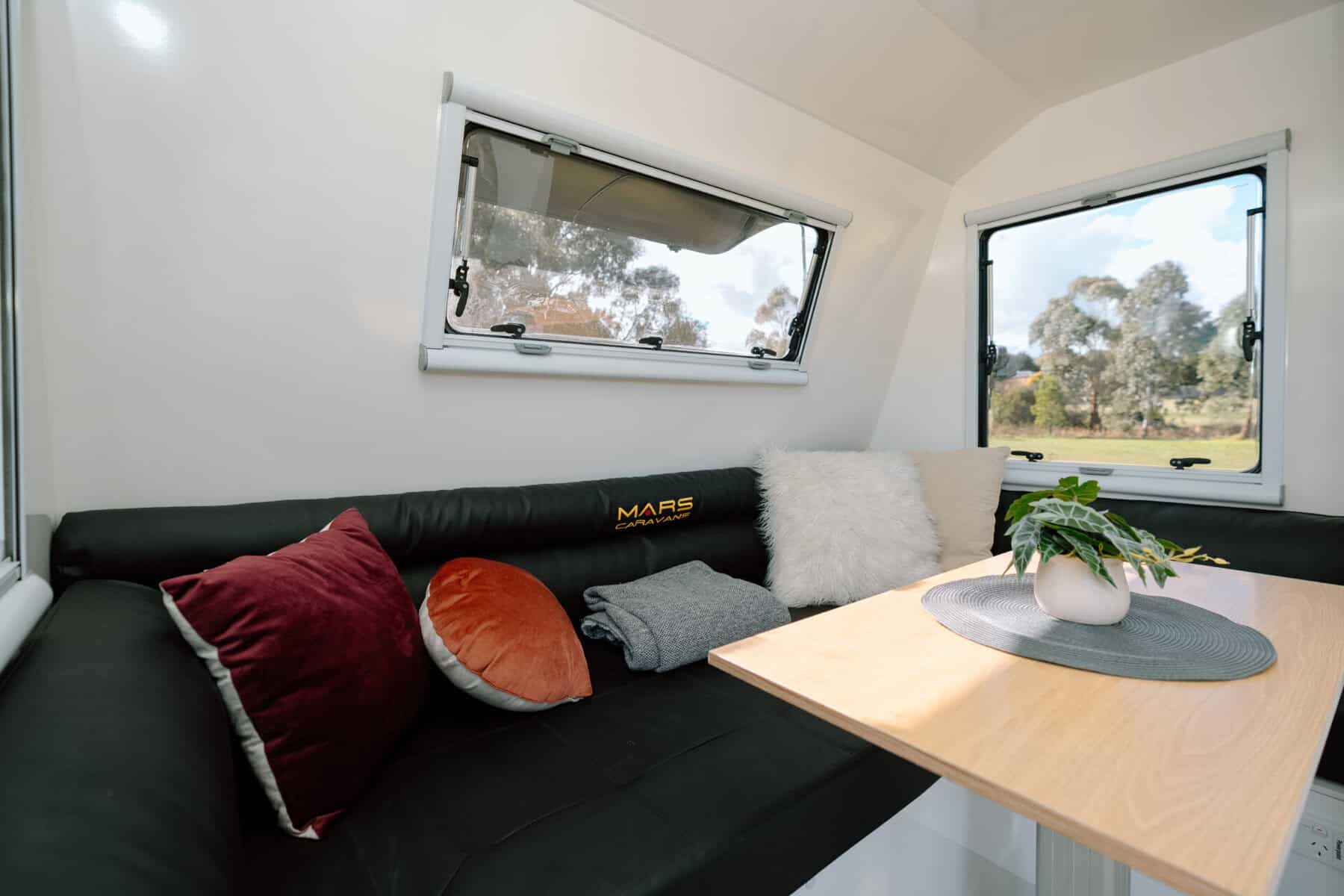 Mars 17HR lightweight on road couples caravan interior convertible club lounge with black leather finish
