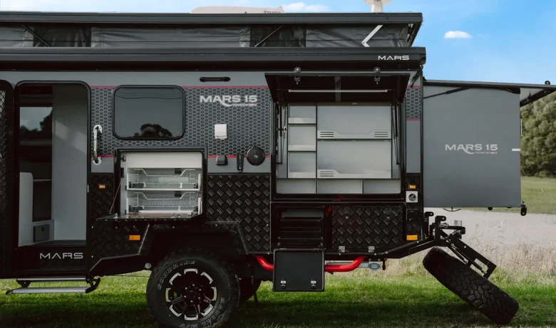 Mars 15 Premium MK 2 couples offroad caravan exterior semi rear view of full setup including pop top and 4.5m electric waterproof awning