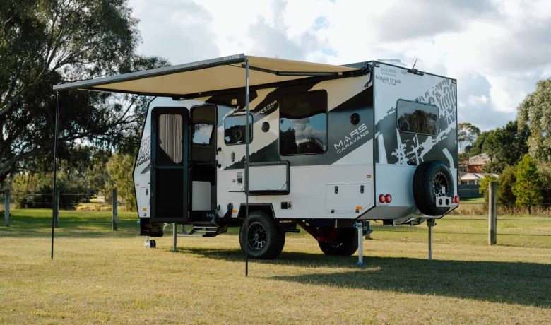 Mars 17HR lightweight on road couples caravan exterior rear angled view with extended waterproof awning